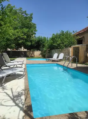 a swimming pool with chaise lounge chairs next to it at Villa Alexandrou in Vamos