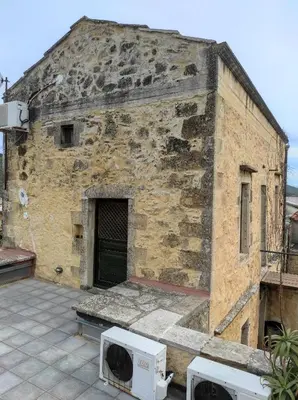 an old stone building with two microwaves on a patio at Villa Alexandrou in Vamos