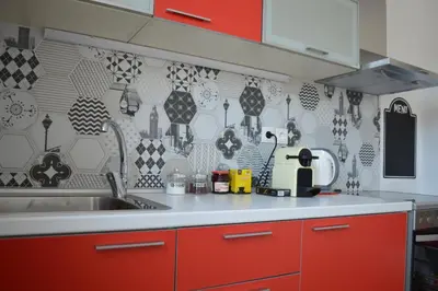 a kitchen with red cabinets and a sink and a kitchen gmaxwell gmaxwell gmaxwell at Antony Home in Kounoupidhianá