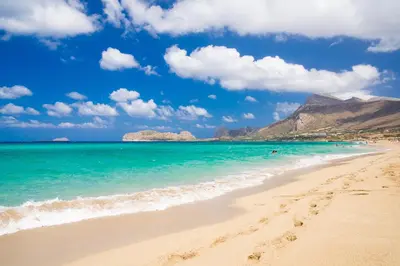 a beach with the ocean and mountains in the background at Emily's House in Kissamos