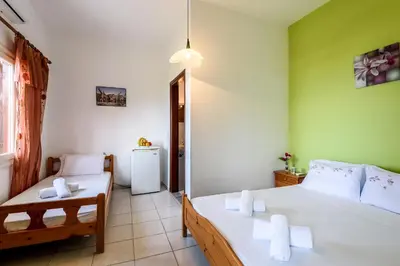 a bedroom with two beds with towels on them at Antonis Studio in Sfinárion