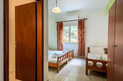 a small room with a bed and a window at Antonis Studio in Sfinárion