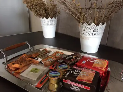 a tray of food on a table with two vases at BO Home in Souda