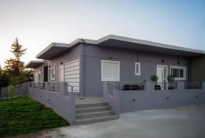 a house with a staircase in front of it at BO Home in Souda