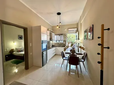 a kitchen and dining room with a table and chairs at BO Home in Souda