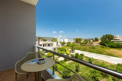 a balcony with a table and chairs and a view at Ethereal Apartments Chania in Souda