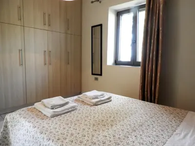 a bedroom with a bed with towels on it at Chrissi's house with garden and sea view Zerviana in Kissamos