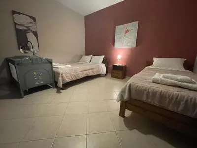 a room with two beds and a tv in it at Chrissi's house with garden and sea view Zerviana in Kissamos