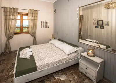 a bedroom with a bed and a large mirror at Kyparissos Apartment I in Kissamos