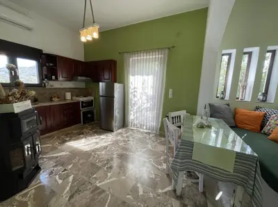 a kitchen with a table and a dining room at Kyparissos Apartment I in Kissamos