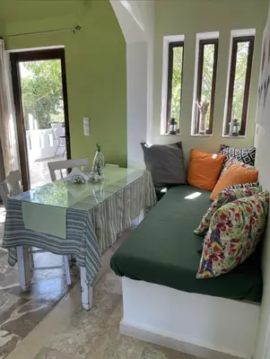 a living room with a couch and a table at Kyparissos Apartment I in Kissamos