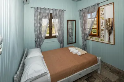 a bedroom with a bed with a stuffed animal on it at Kyparissos Apartment I in Kissamos