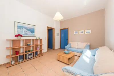 a living room with a couch and a table at Villa SteMa in Xirokámbion