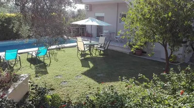 a backyard with a table and chairs and an umbrella at Villa SteMa in Xirokámbion