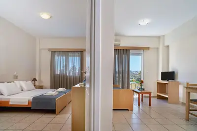 a bedroom with a bed and a living room at Veronica Hotel in Kato Daratso