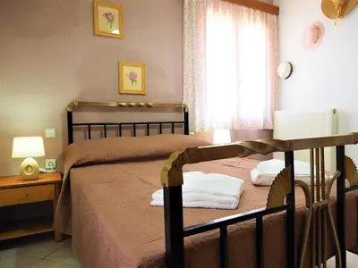 a bedroom with two beds and a window at Traditional Cretan Villa in Rodhopós