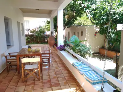 a patio with a table and chairs on a house at Zacharoula's Home in Chania Town