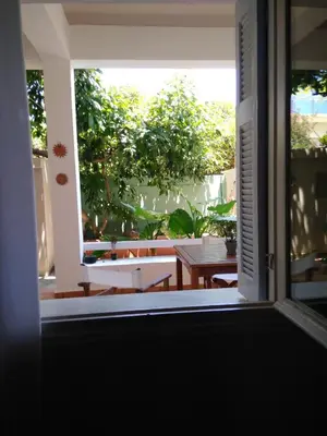 an open door to a patio with a table at Zacharoula's Home in Chania Town