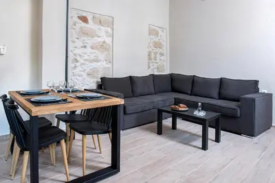 a living room with a couch and a table at Elegant Apartment in Chania Town