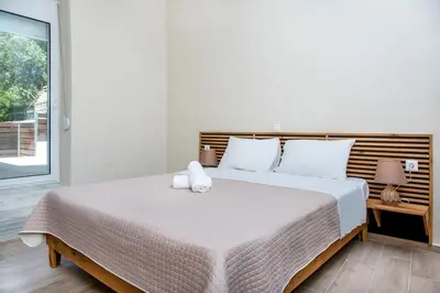 a bedroom with a large bed with white pillows at Elegant Apartment in Chania Town