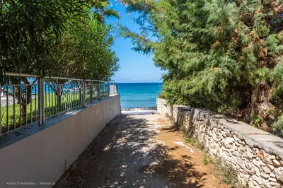 a path to the beach with the ocean in the background at Orama Suites II in Kato Daratso