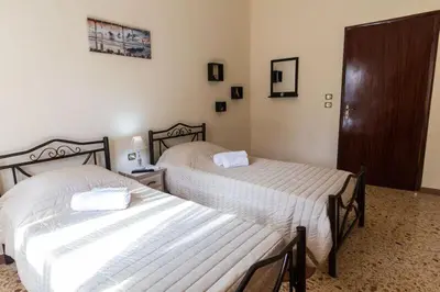 a bedroom with two beds and a cabinet at Stalos View in Stalos