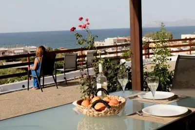 a table with a basket of fruit on a balcony at Stalos View in Stalos