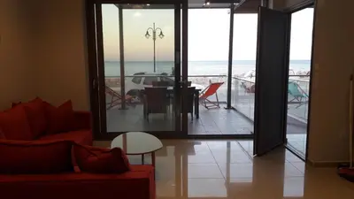 a living room with a view of the ocean at Casa Bella Deluxe Apartments in Palaiochóra
