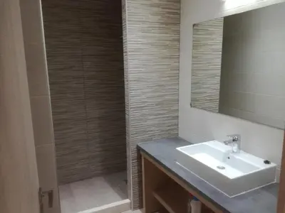 a bathroom with a sink and a shower with a mirror at Casa Bella Deluxe Apartments in Palaiochóra
