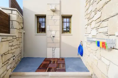 a hallway of a house with a blue floor at Effrosini Traditional Home in Nopíyia