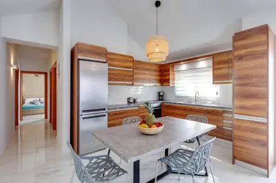 a kitchen with a table with a bowl of fruit on it at Ikia Aretousa in Kato Daratso