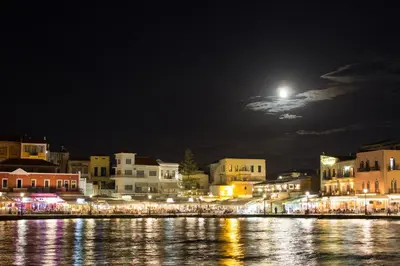 a city at night with the moon in the sky at Ikia Aretousa in Kato Daratso