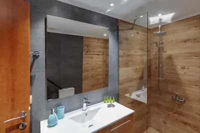 a bathroom with a sink and a shower at Ikia Aretousa in Kato Daratso