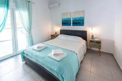 a bedroom with a bed with towels on it at Orama Suites I in Kato Daratso