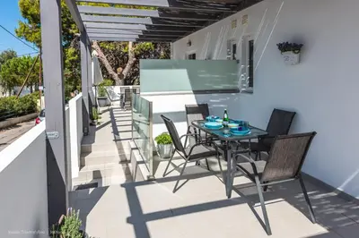 a patio with a table and chairs on a balcony at Orama Suites I in Kato Daratso