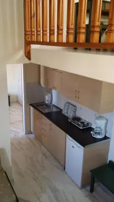 a kitchen with a sink and a counter top at Mythos Beach Hotel Apartments in Maleme