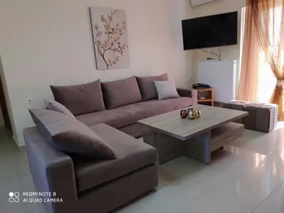 a living room with a couch and a table at Joanna 's Loft in Kissamos