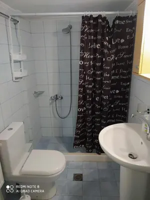 a bathroom with a shower with a toilet and a sink at Joanna 's Loft in Kissamos
