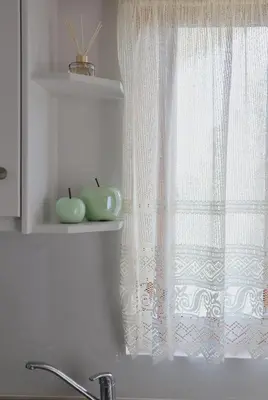 a kitchen window with two apples on a shelf at Villa Elea Apartments in Spiliá