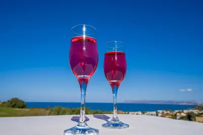 two glasses of red wine sitting on a table at Casa Leone Suites in Stalos