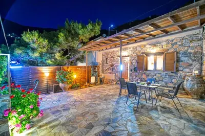 a patio with a table and chairs in front of a building at 
