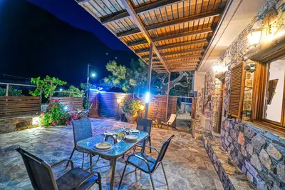 a patio with a table and chairs at night at 