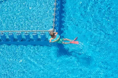a person riding a wave in a swimming pool at Christina Beach Hotel in Kissamos