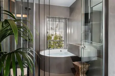 a bathroom with a tub and a sink and a plant at A-Loft Superior Experience in Chania Town