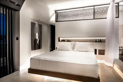 a bedroom with a large white bed and a window at A-Loft Superior Experience in Chania Town