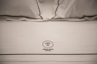 a white bed with a sign that says left room ions crawl at A-Loft Superior Experience in Chania Town