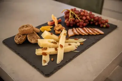 a plate of food with cheese and grapes on a counter at A-Loft Superior Experience in Chania Town