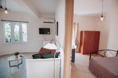 a living room with a couch and a bedroom at Pixelart Home in Kounoupidhianá
