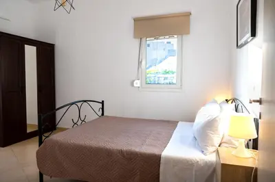 a bedroom with a bed with a lamp and a window at Pixelart Home in Kounoupidhianá