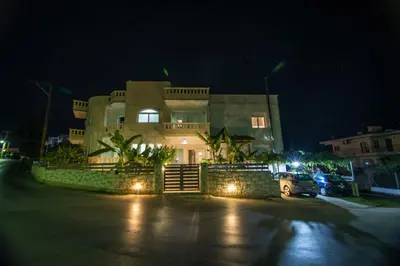 a large house with a car parked in front of it at night at Pixelart Home in Kounoupidhianá